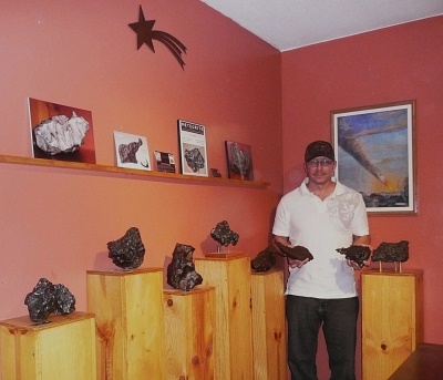 Michael Johnson with eight stunning iron meteorite specimens